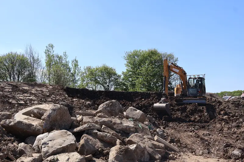 Excavator working through rock during earthworks