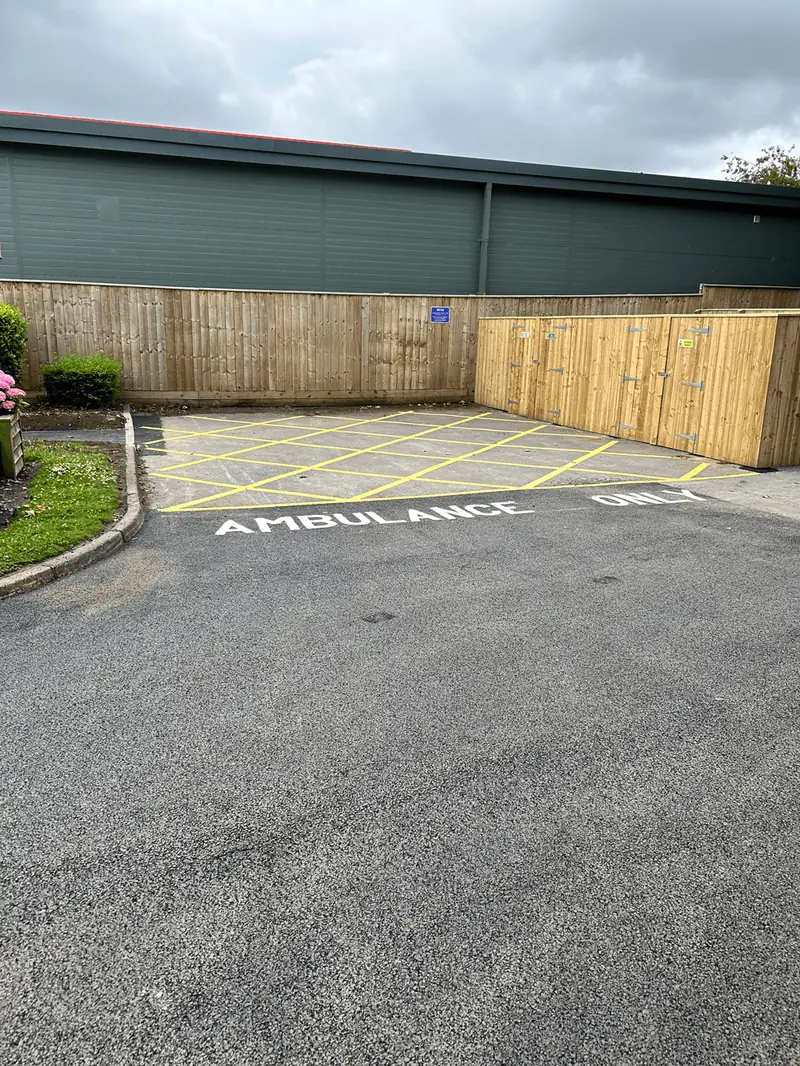 Newly surfaced tarmac yard and timber fencing