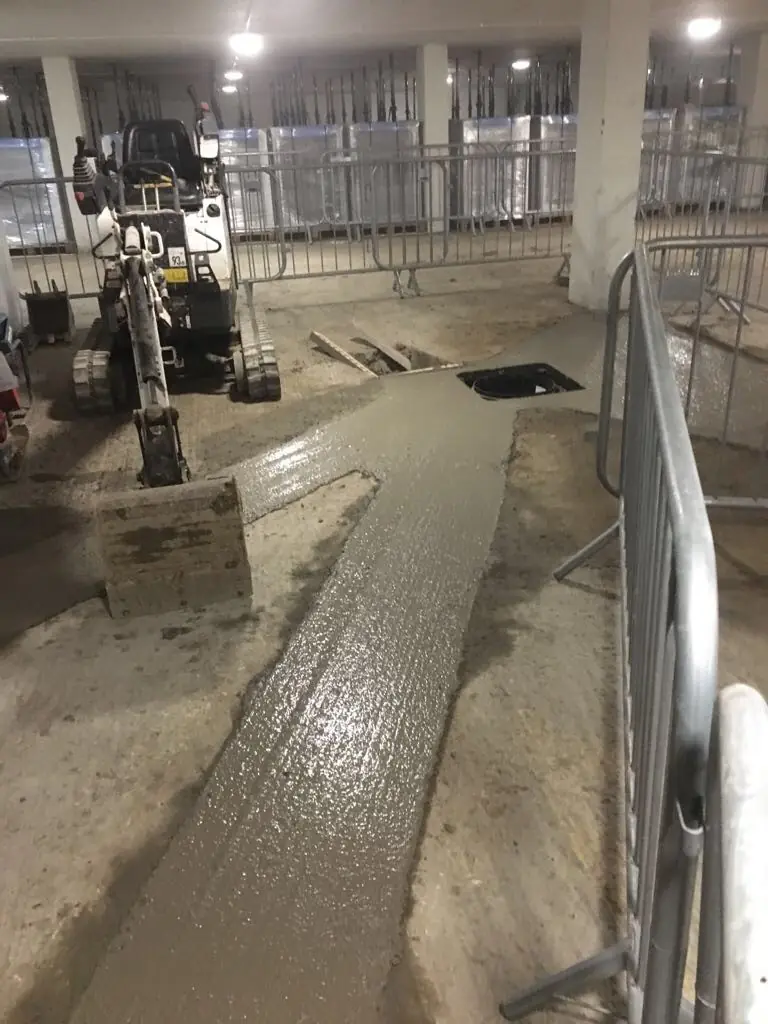 Concrete being poured inside a building