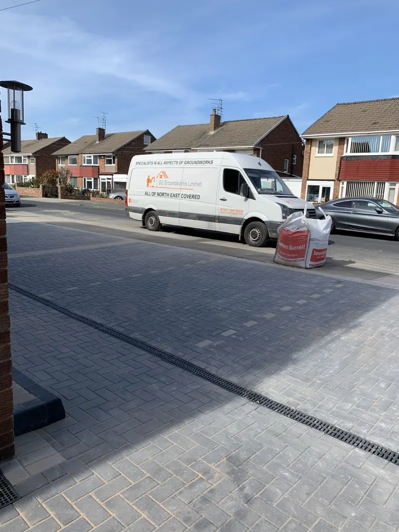 Block paved driveway leading to the street