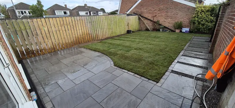 Patio with stepping stones and curved lawn