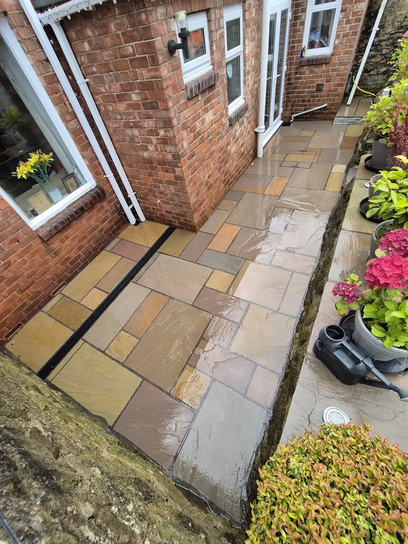 Sandstone patio beside a house