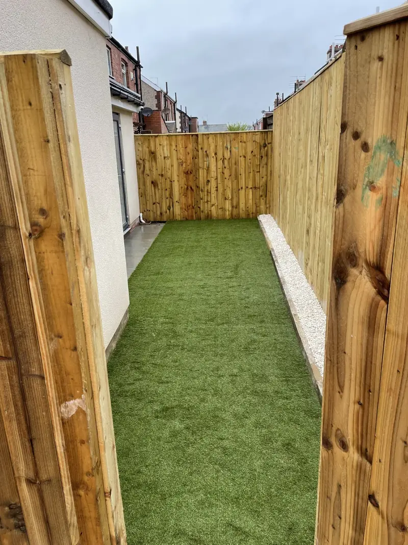 Side garden with lawn and timber fencing